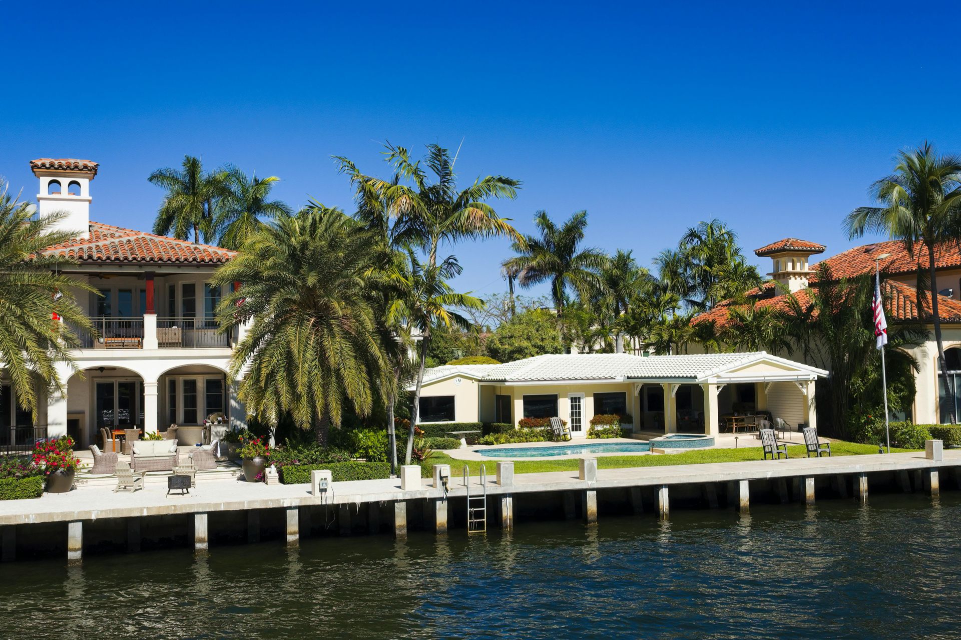 Marine construction crew building a dock and seawall on a residential Florida waterfront